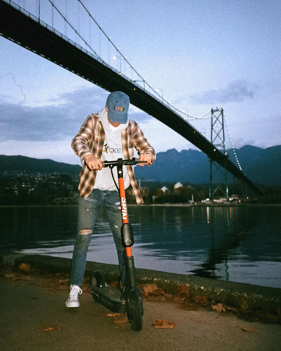 Euwyn with scooter in front of bridge